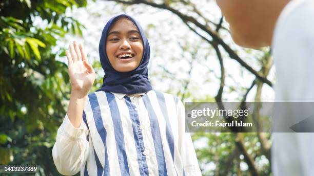 hijab young woman speak in sign language - american sign language stock pictures, royalty-free photos & images