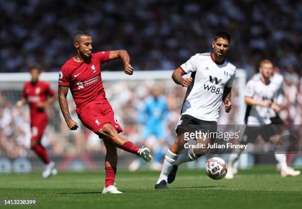 Thiago Alcantara of Liverpool is marked by Aleksandar Mitrovic of Fulham during the Premier League match between Fulham FC and Liverpool FC at Craven...