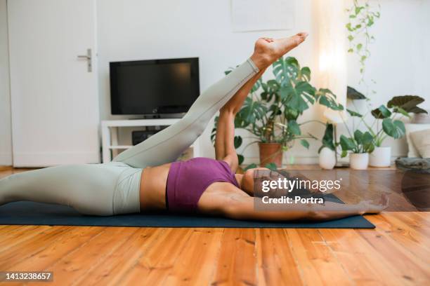 flexible young woman doing stretching yoga at home - doing the splits stock pictures, royalty-free photos & images