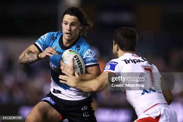 Nicho Hynes of the Sharks takes on the defence during the round 21 NRL match between the Cronulla Sharks and the St George Illawarra Dragons at...