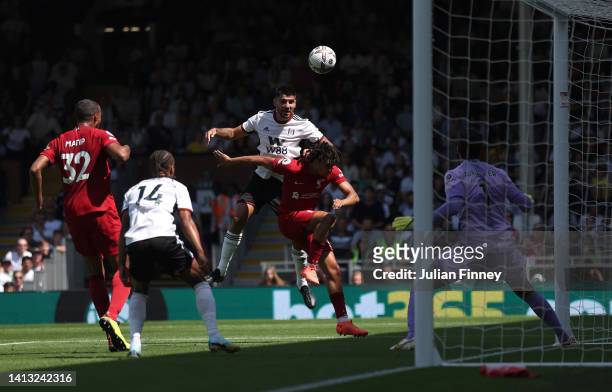 Aleksandar Mitrovic of Fulham scores their side's first goal from a header whilst under pressure from Trent Alexander-Arnold of Liverpool during the...