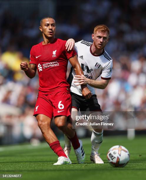 Thiago Alcantara of Liverpool is challenged by Harrison Reed of Fulham during the Premier League match between Fulham FC and Liverpool FC at Craven...