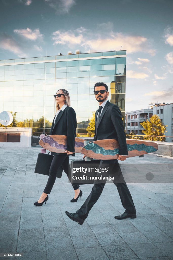Business people with their skateboards