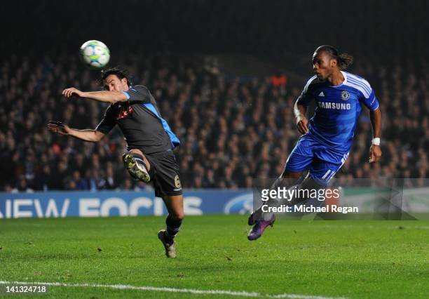 Didier Drogba of Chelsea beats Salvatore Aronica of Napoli to score their first goal with a header during the UEFA Champions League Round of 16...