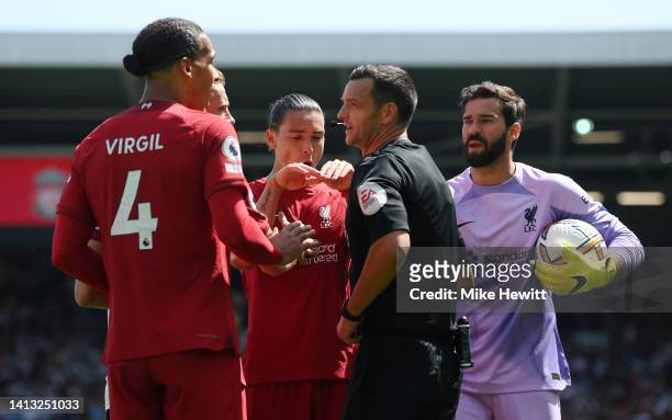 Virgil van Dijk, Jordan Henderson, Darwin Nunez and Alisson Becker of Liverpool protest to Referee Andy Madley after Aleksandar Mitrovic of Fulham is...