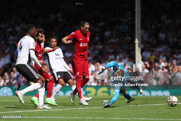 Mohamed Salah of Liverpool scores their side's second goal as Marek Rodak of Fulham attempts to make a save during the Premier League match between...