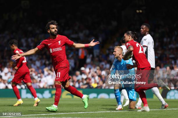 Mohamed Salah of Liverpool celebrates scoring their side's second goal as Marek Rodak of Fulham reacts during the Premier League match between Fulham...