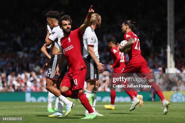 Mohamed Salah of Liverpool celebrates scoring their side's second goal reacts during the Premier League match between Fulham FC and Liverpool FC at...