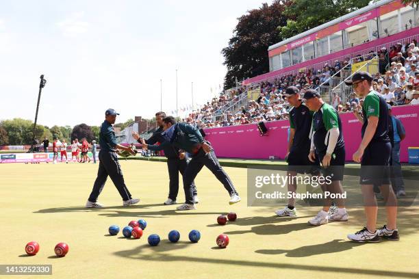 Dinesh Kumar, Sunil Bahadur and Navneet Singh of Team India interact during Men's Fours - Gold Medal Match between Northern Ireland and India on day...