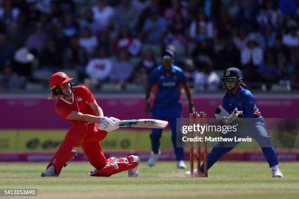 Nat Sciver of Team England sweeps the ball as Taniyaa Bhatia of Team India looks on during the Cricket T20 - Semi-Final match between Team England...