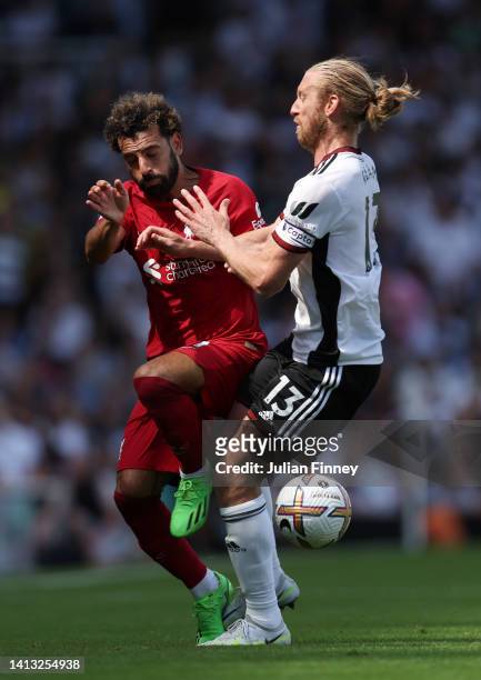 Mohamed Salah of Liverpool is challenged by Tim Ream of Fulham during the Premier League match between Fulham FC and Liverpool FC at Craven Cottage...