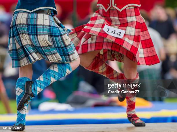 dancers performing at a highland games event in scotland - woman kilt stock pictures, royalty-free photos & images
