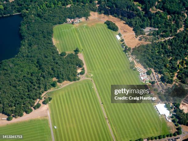 high angle aerial view of traditional english polo club and or racecourse with green fields looking beautiful in the summer sun - polo stock pictures, royalty-free photos & images
