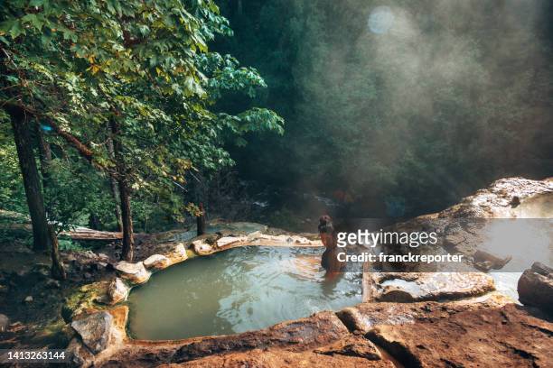 woman resting in an hot spring in oregon - hot spring stock pictures, royalty-free photos & images