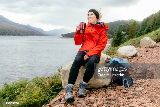 taking a break on a long walk in the scottish highlands - regnkläder bildbanksfoton och bilder