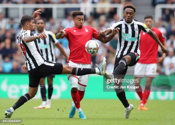 Jesse Lingard of Nottingham Forest is challenged by Bruno Guimaraes and Joe Willock of Newcastle United during the Premier League match between...