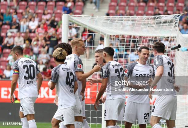 Michael Gregoritsch of SC Freiburg celebrates scoring their side's first goal with teammates during the Bundesliga match between FC Augsburg and...
