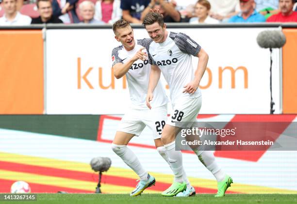 Matthias Ginter of SC Freiburg celebrates scoring their side's third goal with teammate Michael Gregoritsch during the Bundesliga match between FC...