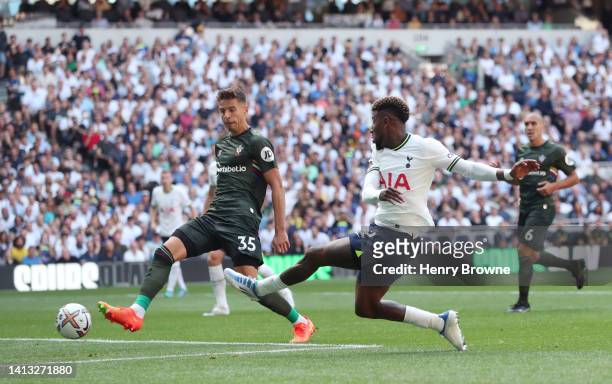 Emerson of Tottenham Hotspur scores their side's third goal whilst under pressure from Jan Bednarek of Southampton during the Premier League match...