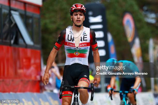 Joao Almeida of Portugal and UAE Team Emirates celebrates winning ahead of Miguel Ángel López Moreno of Colombia and Team Astana – Qazaqstan during...