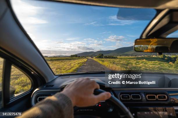 personal perspective of person driving a car on country road in asturias, spain - driver seat stock pictures, royalty-free photos & images