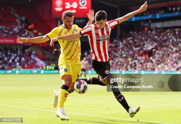 Anel Ahmedhodzic of Sheffield United is challenged by Mason Bennett of Millwall during the Sky Bet Championship match between Sheffield United and...