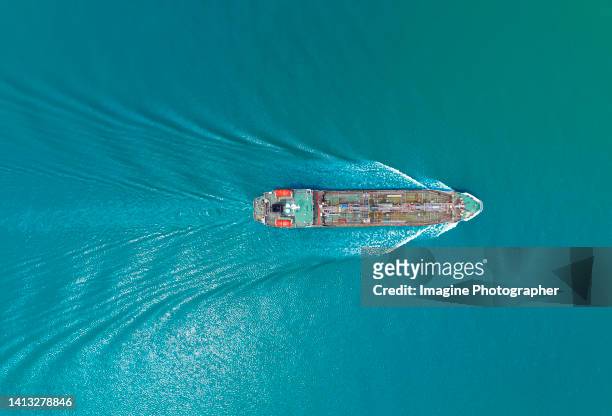 aerial top view, green oil tankers, orange lifeboats at the bow are running at high speed and beautiful waves in the sea. about the energy and oil business. - offshore oil stock pictures, royalty-free photos & images