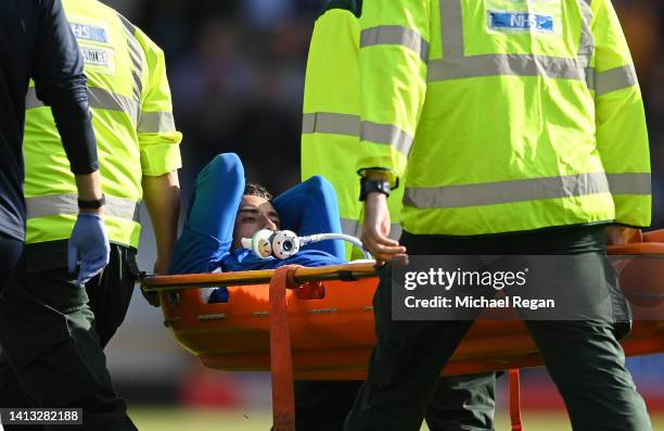 Ben Godfrey of Everton is stretchered off the pitch after receiving medical treatment during the Premier League match between Everton FC and Chelsea...