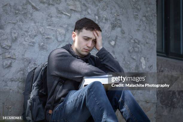 stressed mixed-race student struggling with poor mental health - bullying prevention stock pictures, royalty-free photos & images