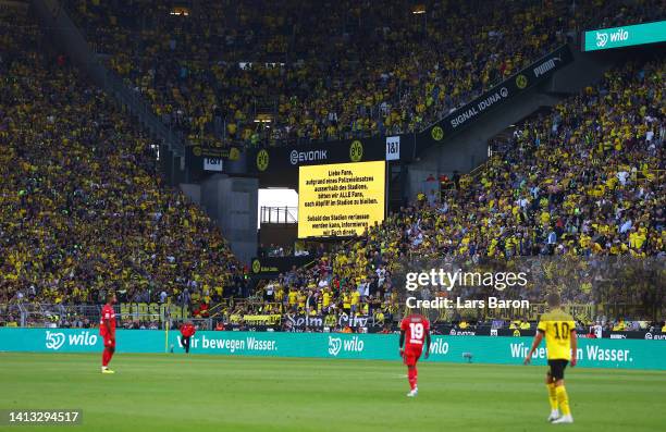 General view of the inside of the stadium as the LED Screen displays a message informing fans to remain inside the stadium after the final whistle...