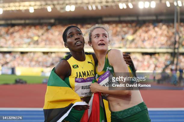 Gold medalist Janieve Russell of Team Jamaica and bronze medalist Zeney van der Walt of Team South Africa celebrate following the Women's 400m...