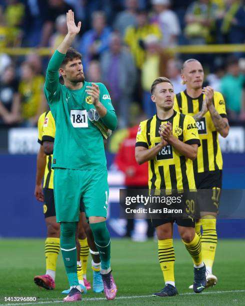 Gregor Kobel and Felix Passlack of Borussia Dortmund applauds their fans after the final whistle of the Bundesliga match between Borussia Dortmund...