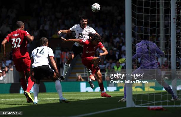 Aleksandar Mitrovic of Fulham scores the first goal with a header during the Premier League match between Fulham FC and Liverpool FC at Craven...