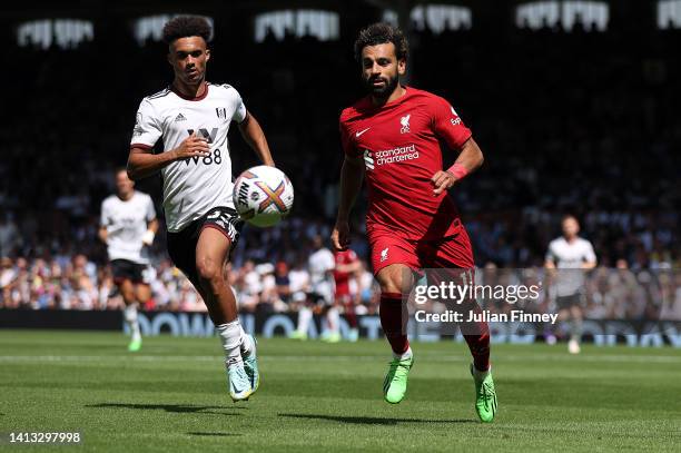 Mohamed Salah of Liverpool is challenged by Antonee Robinson of Fulham during the Premier League match between Fulham FC and Liverpool FC at Craven...