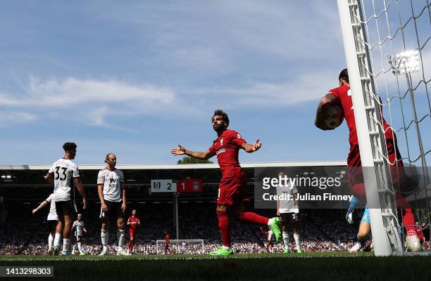Mohamed Salah of Liverpool celebrates scoring their side's second goal during the Premier League match between Fulham FC and Liverpool FC at Craven...