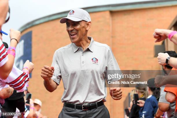 Hall of Fame head coach Tony Dungy celebrates with fans as he is introduced prior to the 2022 Pro Hall of Fame Enshrinement Ceremony at Tom Benson...