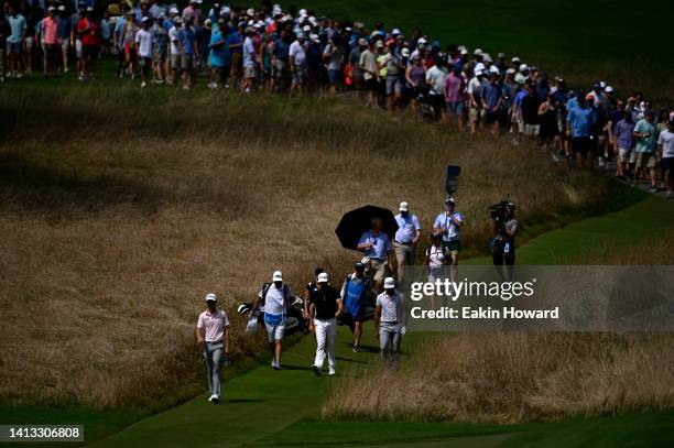 Will Zalatoris of the United States, Rafa Cabrera Bello of Spain and Yannik Paul of Germany walk from the sixth tee during the third round of the...