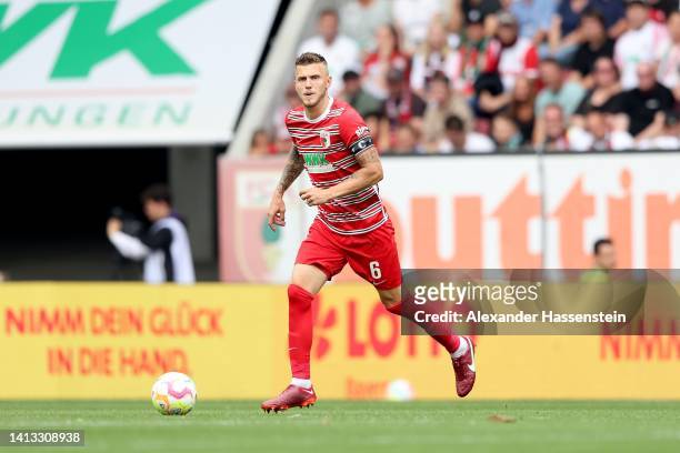 Jeffrey Gouweleeuw of Augsburg runs with the ball during the Bundesliga match between FC Augsburg and Sport-Club Freiburg at WWK-Arena on August 06,...