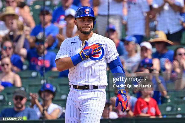 Willson Contreras of the Chicago Cubs reacts on first base after his RBI single in the fifth inning against the Miami Marlins at Wrigley Field on...