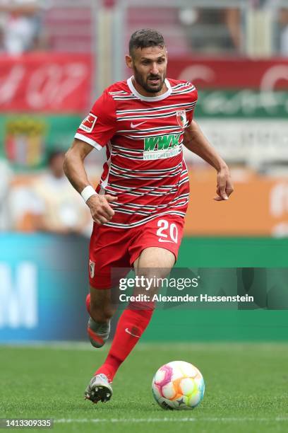 Daniel Caligiuri of Augsburg runs with the ball during the Bundesliga match between FC Augsburg and Sport-Club Freiburg at WWK-Arena on August 06,...