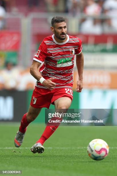 Daniel Caligiuri of Augsburg runs with the ball during the Bundesliga match between FC Augsburg and Sport-Club Freiburg at WWK-Arena on August 06,...