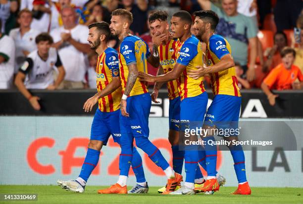 Hugo Duro of Valencia CF celebrates after scoring their side's first goal with his teammates during the 50th Edition of Trofeu Taronja match between...