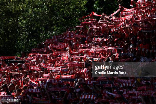 Fans of Union Berlin cheer during the Bundesliga match between 1. FC Union Berlin and Hertha BSC at Stadion an der alten Försterei on August 06, 2022...