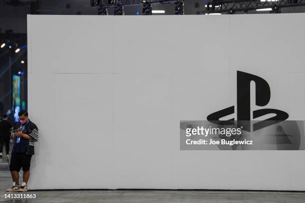 An EVO 2022 attendee takes a break in front of the Playstation booth at Mandalay Bay Resort and Casino on August 06, 2022 in Las Vegas, Nevada.
