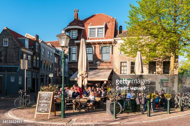 group of people on a terrace, dordrecht, holland. - dordrecht stock pictures, royalty-free photos & images