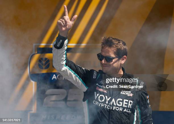 Landon Cassill, driver of the Chevy Accessories Chevrolet, walks onstage during driver intros prior to the NASCAR Xfinity Series New Holland 250 at...