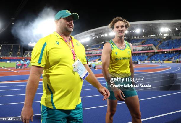 Kurtis Marschall of Team Australia celebrates winning the gold medal with Coach Paul Burgess following the Men's Pole Vault Final on day nine of the...