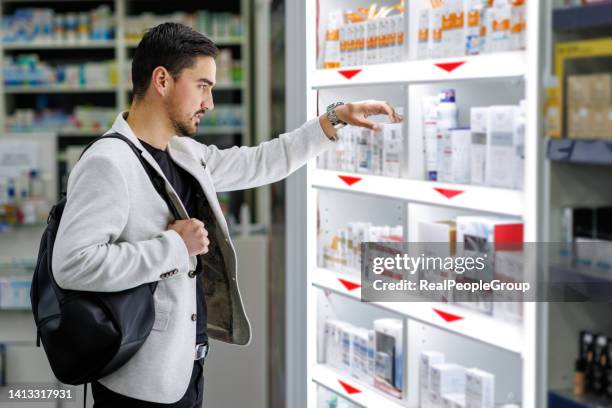 not sure which pills i should take - man pharmacy aisle stock pictures, royalty-free photos & images
