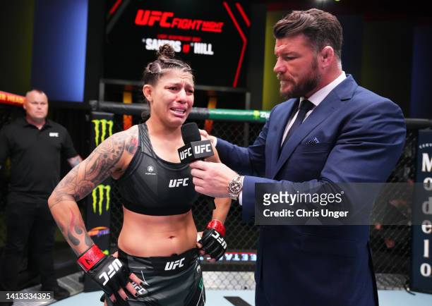 Mayra Bueno Silva of Brazil is interviewed by Michael Bisping after her victory over Stephanie Egger of Switzerland in a bantamweight fight during...
