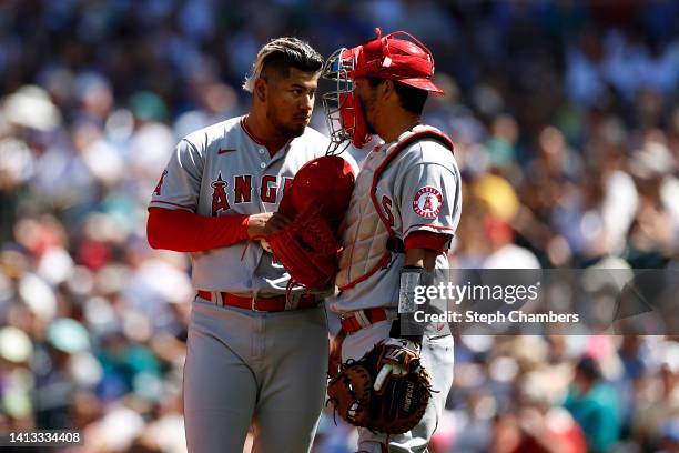 Jaime Barria and Kurt Suzuki of the Los Angeles Angels talk during the third inning against the Seattle Mariners at T-Mobile Park on August 06, 2022...